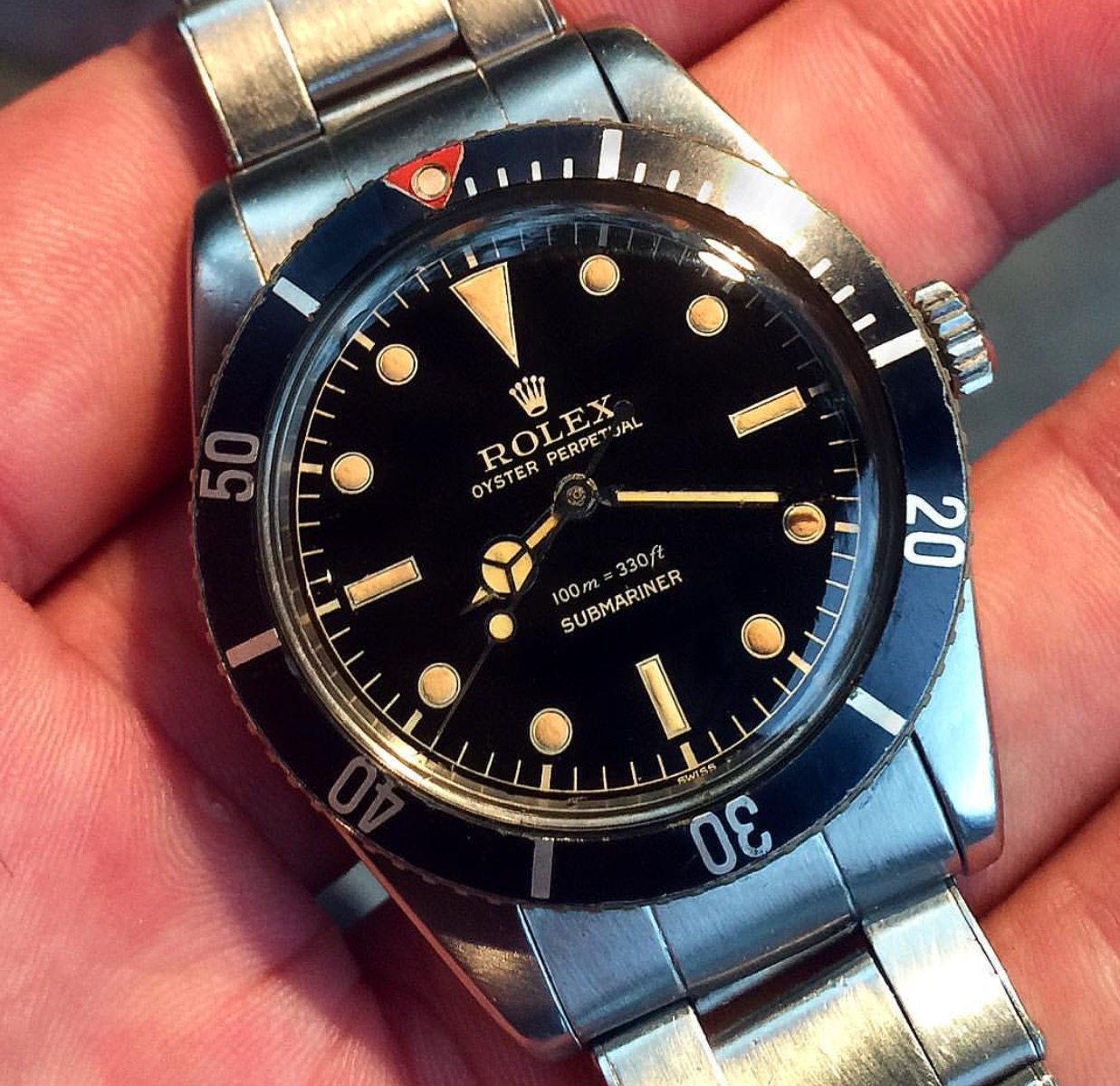 rolex submariner red triangle